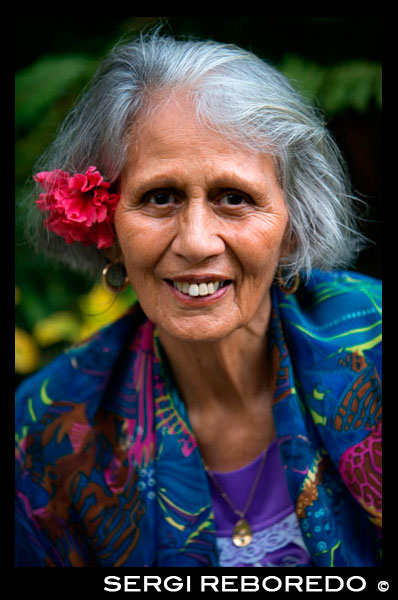 Rarotonga Island. Cook Island. Polynesia. South Pacific Ocean. An elderly woman dressed in modern suits of Polynesian. Fashion in the Pacific is renowned for its vivid colours and patterns. A Cook Islands woman has taken this distinct style and created a unique line of high end fashion. Not only that, Ellena Tavioni and her label TAV have caught international attraction, strutting a very Pacific style on the world fashion stage. Designers on Rarotonga are hand-screening Polynesian-inspired images on fabrics to create small but interesting ranges of clothing for women, men and children. These are distinctive designs printed on quality fabrics. Lengths of fabric can be bought to take home as well, to use in a variety of ways including window drops, curtains, wall hangings, bed covers, throws or wraps. Or made up into unique made-to-measure garments. There is plenty of choice in the cheap and cheerful holiday range on Rarotonga with several outlets selling clothes imported from Bali, Indonesia, India, China and Australia. Others have popular brands of surf clothing for youngsters and the young at heart. T-shirts are always in demand and Cook Islands designers have taken them to a new level with an enormous range of cheeky souvenir Tees. Those looking for something more aesthetic will enjoy the Polynesia-inspired designs by local artists.