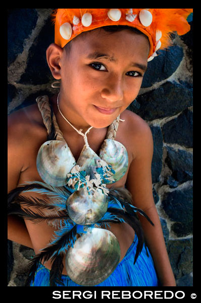 Rarotonga Island. Cook Island. Polynesia. A boy dressed as a dancer of the Cook Island around the Punanga Nui Markets. To the despair of many educated Cook Islanders the expression "culture" in the popular mind equates to traditional festivals, singing and dancing. There is some justification for this since the art of dance is taken very seriously in the Cooks. Each island has its own special dances and these are practised assiduously from early childhood. There are numerous competitions throughout the year on each island – Events – and these are hotly contested. The highly rhythmic drumming on the paté and the wild and sensuous movements of both men and women virtually guarantee that Cook Islands teams win all the major Pacific dance festivals.The Hawaiian hula and the Tahitian tamuré are probably better known because those islands have had wider publicity for the last 100 years but the Cook Islands hura is far more sensual and fierce. Every major hotel prides itself on the performance it puts on at least once a week on Island Night when guests, selected by the dancers, are led onto the floor to show what they can do. Cook Islands dancing. It there is one outstanding ability which appears to be shared by all Cook Islanders it is music and song. Close harmony singing is highly developed in church music and the power and emotional impact of chants and hymns at weddings and funerals is well known to visitors who attend. The range and talent of popular singing can be seen at the numerous festivals throughout the year (see Events). Each island also has its own songs and the various island groups compete fiercely. There are numerous Polynesian string bands who play at restaurants, hotels and concerts and they use combinations of modern electronics with traditional ukeleles fashioned from coconut shells.