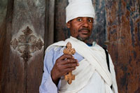 A priest sits majestically with his cross in front of the Monastery of Birgida Maryam on one of the islands of Lake Tana. Lake Tana, the largest lake in Ethiopia is the source of the Blue Nile which begins its long journey to Khartoum and on to the Mediterranean. The 37 islands that are scattered over the surface of the churches and monastries wrap fascinating lake, some of which have histories dating back to the thirteenth century. However, it should be noted that most of the religious houses are not open to women. The most interesting islands are: Birgida Mariam, Dega Estefanous, DEK, Narga, Tana Cherkos, Mitsele Fasiledes, Kebran and Debre Maryam.