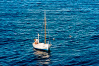 Formentera. Fisher with traditional fishing boat in summer day. Llaüt. 