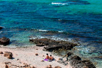 Formentera. Nude couple in Es caló des Mort, Migjorn beach, Formentera, Balears Islands, Spain. Holiday makers, tourists, Es caló des Mort, beach, Formentera, Pityuses, Balearic Islands, Spain, Europe.