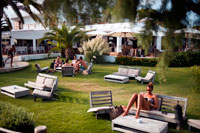 Formentera. Gecko boutique de lujo Hotel, playa de Migjorn, Formentera, Islas Baleares, España, Europa. Las personas que leen y que se relajan en el jardín