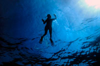 Formentera. Girl diving in Arch area, Formentera, Balearic Islands, Mediterranean Sea, Spain. The Arch offers a rich, recreational seascape. It is an ideal dive site to brush up on your diving techniques or to simply enjoy a pleasant dive. Diving at the Arch is perfect for practicing your diving technique because diving can take place at all levels: from 3 to 15 metres, with a progressive depth gradient. The Arch is also one of the best dive sites in Formentera for initiation dives, as it offers a fascinating dive at shallow depths.