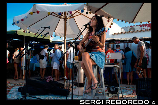 Live music in Hippy Market, Pilar de la Mola, Formentera, Balearic Islands, Spain, Europe Spain; Formentera; island; hippy; market; Pilar de la Mola; live; song; sing; singer; female; woman; rock; music; guitar; instrument; mola; tourists; souvenirs; craft; fair; balearic; eco; fashion; cheap; cheaper; ecological; alternative; sell; buy; Baleares; atrraction; destination; Europe; European; holiday; travel; islands; mediterranean; photos; place; spanish; sun; tourism; touristic; vacation; view; Balearics; beautiful; beauty; paradise; fun; happy; coastal; paradisiac; popular