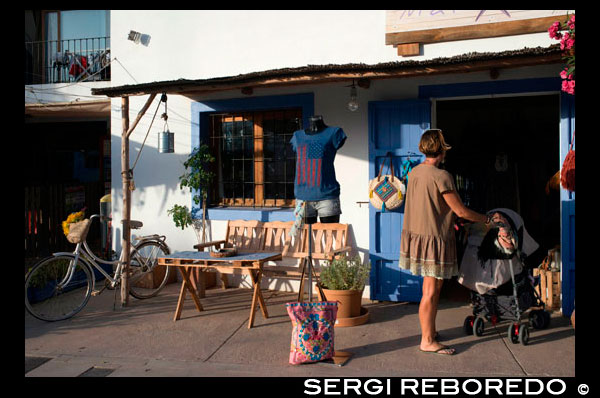 Hippy shops, Pilar de la Mola, Formentera, Balearic Islands, Spain, Europe Spain; Formentera; island; hippy; market; Pilar de la Mola; mola; tourists; souvenirs; craft; fair; balearic; t-shirts; shirts; mother; travel; with; children; eco; fashion; bicycle; bike; white; house; cheap; cheaper; ecological; alternative; sell; buy; Baleares; atrraction; nice; girls; souvenir; woman; women; people; destination; Europe; European; holiday; travel; islands; mediterranean; photos; place; spanish; sun; tourism; touristic; vacation; view; Balearics; beautiful; beauty; paradise; fun; happy; coastal; paradisiac; popular