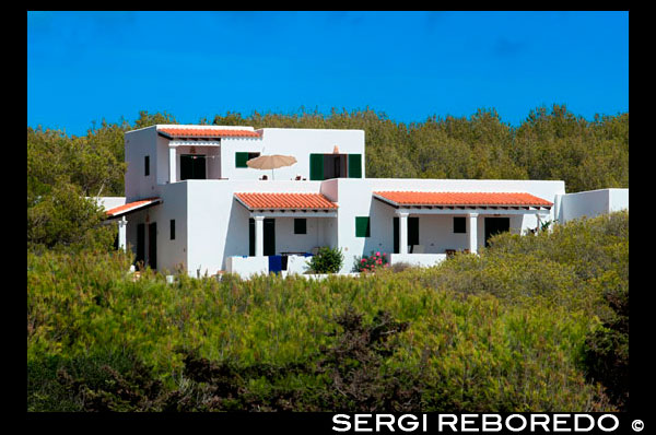 Typical white house of Formentera. Migjorn beach, Formentera island, Balears Islands, Spain.  Spain; Formentera; island; typical; house; houses; Migjorn; rustic; beach; dunes; dry; white; aged; ancient; architecture; art; balearic; bars; blue; mansion; hamlet; homestead; land; building; buildings; coast; construction; country; door; environment; europe; fan; farm; formentera; holiday; home; house; ibiza; islands; landscape; masonry; mediterranean; nature; old; retro; rock; rural; rustic; spain; stone; street; style; texture; tile; tourism; town; traditional; travel; typical; view; village; wall; white; window; windows; wooden; yellow; balearic; Baleares; atrraction; destination; Europe; European; holiday; travel; islands; mediterranean; photos; place; spanish; sun; tourism; touristic; vacation; view; Balearics; beautiful; beauty; paradise; fun; happy; coastal; paradisiac; popular