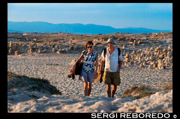 Sa Roqueta Beach and Ses Illetes Beach, Balearic Islands, Formentera, Spain. Couple walking in the sand.  Spain; Formentera; island; Ses Illetes; beach; sa roqueta; illetes; roqueta; coastline; marine; scene; outdors; sand; summer; balearic; nice; sea; boats; pretty; sunset; couple; walk; walking; sand; beauty; calo; beach; beautiful; beauty; blue; coast; people; man; woman; romantic; europe; holiday; idyllic; isla; island; islands; islet; landmark; landscape; mediterranean; nature; ocean; outdoor; paradise; places; rock; rocky; san; scenic; sea; seascape; shallow; shore; sky; spain; stones; holiday; horizon; islands; length; look; med; mediterranean europe; platge; platja; playa; rear; rocks; rocky; rough; sand; sandy; sea; single; slim; spain; spanish; stand; summer; tourism; travel; vacation; view; watch; wave; sun; sunny; touristic; transparent; travel; turquoise; vacation; water; waves; white; balearic; Baleares; atrraction; destination; Europe; European; holiday; travel; islands; mediterranean; photos; place; spanish; sun; tourism; touristic; vacation; view; Balearics; beautiful; beauty; paradise; fun; happy; coastal; paradisiac; popular