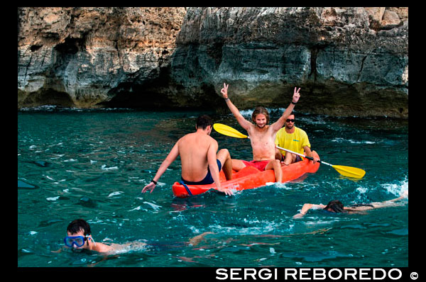 Friends doing kayaking on Cala Sahona, Formentera, Balearics Islands, Spain. Barbaria Cape. Spain; Formentera; kayak; kayaking; tradictional; beach; sea; Cala Sahona; Sahona; inlet; beautiful; friends; blue; people; clear; coast; coastline; crystalline; active; tourism; funny; happy; els; fishing; formentera; holiday; ibiza; idyllic; island; islands; landmark; landscape; mediterranean; nature; ocean; outdoor; paradise; pier; places; port; pujols; rail; railway; rock; scenic; sea; seascape; spain; stranded; summer; sunny; touristic; traditional; transparent; travel; turquoise; typical; vacation; water; white; wooden; island; balearic; Baleares; atrraction; destination; Europe; European; holiday; travel; islands; mediterranean; photos; place; spanish; sun; tourism; touristic; vacation; view; Balearics; beautiful; beauty; paradise; fun; happy; coastal; paradisiac; popular