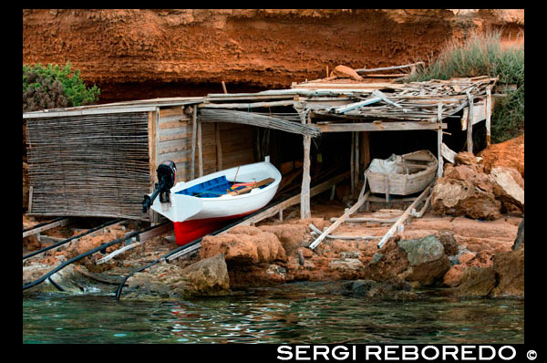 Traditional fishing boat in summer day. Llaüt boats. Cala Sahona, Formentera, Balearics Islands, Spain. Barbaria Cape. Spain; Formentera; llaut; llaüt; boat; tradictional; beach; sand; park; parking; pier; jetty; Cala Sahona; Sahona; inlet; beached; beautiful; blue; boat; clear; dock; coast; coastline; crystalline; els; fishing; formentera; holiday; ibiza; idyllic; island; islands; landmark; landscape; mediterranean; nature; ocean; outdoor; paradise; pier; places; port; pujols; rail; railway; rock; scenic; sea; seascape; spain; stranded; summer; sunny; touristic; traditional; transparent; travel; turquoise; typical; vacation; water; white; wooden; island; balearic; Baleares; atrraction; destination; Europe; European; holiday; travel; islands; mediterranean; photos; place; spanish; sun; tourism; touristic; vacation; view; Balearics; beautiful; beauty; paradise; fun; happy; coastal; paradisiac; popular