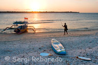 Some boats rest on the sandy beach in the west of the island, near the pier Bounty Resort. Gili Meno.