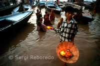 Flores vendedor para obtener la bendición - Varanasi - India. Dasaswamedh Ghat cae segundo en la línea de la Yatra Panch-Tirtha. Cuando comience a desplazarse hacia el norte de Assi cae más allá de la llanura, la construcción de techo plano que alberga el santuario de Shitala. El nombre de Dasaswamedh Ghat indica que Brahma sacrificado (MEDH) 10 caballos aquí. Céntrica, es uno de los ghats más importante y concurrido y por lo tanto es un buen lugar para quedarse y disfrutar de la atmósfera. Dasaswamedh es una peregrinación muy popular. Incluso en la temporada de lluvias, cuando Ganges está en racha, la gente se puede ver visitando el templo de los barcos. Es interesante saber que Shitala representa los dos aspectos benignos y malignos de la vida, la facilidad y socorro, así como la enfermedad. Dasaswamedh puede ser juzgado de forma segura como el Ghat más populares y de fácil acceso de Varanasi. Es muy fácil de localizar este Ghat por su ambiente típico que consiste en filas de pandas sentado en las plataformas de madera bajo sombrillas de bambú. Esta es la escena más destacados de Varanasi en todo el mundo. Este lugar aparece en todas las posibles pinturas y fotografías de Benarés. El lugar se parece a un mini India en sí mismo. Masajistas comparten espacio con a veces irritante barqueros que se disputan a los clientes todo el tiempo. 