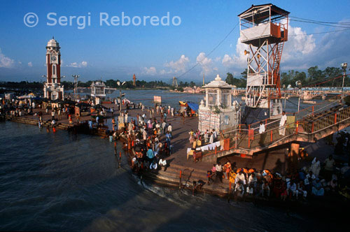 INDIA CROSSING THE RIVER GANGES One of the most famous and most visited sites of Haridwar; Har ki Pauri is considered as one of its five main holy sites. Ganga Aarti takes place on the ghat in the evening; after sunset. A group of Brahmans hold huge fire bowls in their hands and offer their holy mantras to river Ganges; Shiva - the Hindu God of destruction; Surya - the Sun God and the entire Universe. The devotees then offer flowers and earthen lamps - diyas - to river Ganges; in order to pay due regards to their ancestors in heaven. The scenario at Har ki pauri at the time of Ganga-Aarti is mesmerizing. Har Ki Pauri is the place where the divine nectar fell from celestial Kumbh. The Kumbh mela is held here (last held in 1998; next in 2010). The holy river Ganga; enters Brahmakund from one side and exits from the other. Though the water here is around waist-high; one has to be very cautious while bathing on the Ghats since the flow is swift and speedy. Chains and rails have been provided to enable devotees to catch on safely while they take a holy dip. Famous temples - Ganga Mandir and Haricharan mandir are also located here. Har Ki Pauri gets its name from the feet (Pauri) of lord (Hari). Vishnucharanpaduka; the footprints of the Lord; are believed to be imprinted on the wall beneath the waters of Ganga here and with the guidance of a priest; it is also possible to touch it.