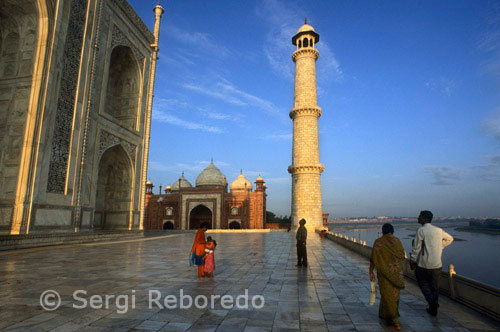 INDIA CROSSING THE RIVER GANGES The Taj Mahal is a mausoleum complex built by Shah Jahan (reg. 1628 - 1658) in memory of his favorite wife; Arjumand Banu Begam (d.1631); better known by her title "Mumtaz Mahal;  or ; the exalted one of the palace." The construction of the complex began shortly after Mumtaz's death; and accounts of this process were popularized by foreign travelers who visited Mughal courts. The tomb's fame increased tremendously following the British occupation of India in the late 18th century. The Taj Mahal complex is organized in a rectangle; measuring approximately 310 x 550 meters. It comprises a number of buildings and structures; all functioning together as the funerary monument for Mumtaz Mahal. From the south; the first part of the complex consists of a (former) bazaar; the forecourt and entry gates; the second part consists of a large garden and garden pavilions; axially arranged along a riverfront terrace with the three main structures: the mosque; the mausoleum and the mihmankhana (literally; "guest house,"; probably used as an assembly hall).