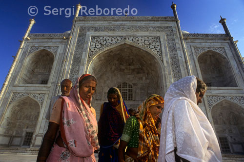 INDIA CROSSING THE RIVER GANGES The Taj Mahal is a mausoleum complex built by Shah Jahan (reg. 1628 - 1658) in memory of his favorite wife; Arjumand Banu Begam (d.1631); better known by her title "Mumtaz Mahal;  or ; the exalted one of the palace." The complex was planned on the basis of a unit called a gaz; approximately 32 inches (81.28 cm). Multiples of this "gaz" unit were used throughout the Taj Mahal complex. Overall; the complex is organized in 3 linearly arranged modular squares; each measuring 374 gaz per side; or 374 gaz wide by 1; 122 gaz long. The caravanserai (Taj Ganj) and entry forecourt (jilaukhana) areas are organized on a module of 17 gaz; whereas in the area from the entry gate (darwaza-i rauza) to the riverfront terrace; the complex follows a 23-gaz module. This 17-gaz jilaukhana module multiplied by 22= 74 gaz (the width of the complex). The caravanserai measures 416.5 gaz in length; or 17 x 24.5 gaz; and the jilaukhana measures 153 gaz; or 17 x 9 gaz. The garden is further divided into 23 x 16 gaz; and the riverfront terrace measures 138 by 23 x 6 gaz. These gaz modules lend themselves to an axial arrangement; with a cascading hierarchy: each building in the complex is further organized on a smaller grid based on the gaz module. For example; the mosque; mausoleum and mihmankhana are based on a 7-gaz grid; while the great gate (darwaza-i rauza) is based on a 3-gaz grid. This grid functions not only in plan; but also in elevation. 