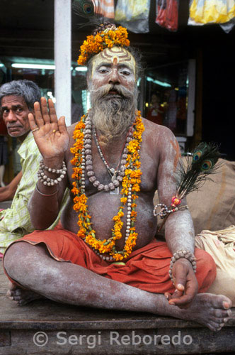 INDIA CROSSING THE RIVER GANGES Varanasi sadhu. In Hinduism; sadhu; or shadhu is a common term for a mystic; an ascetic; practitioner of yoga (yogi) and/or wandering monks. The sadhu is solely dedicated to achieving the fourth and final Hindu goal of life; moksha (liberation); through meditation and contemplation of Brahman. Sadhus often wear ochre-colored clothing; symbolizing renunciation. Sadhus are sanyasi; or renunciates; who have left behind all material and sexual attachments and live in caves; forests and temples all over India and Nepal. A Sadhu is usually referred to as Baba by common people. The word 'baba' also means father; grandfather; or uncle in many Indian languages. Sometimes the respectful suffix 'ji' may also be added after baba; to give greater respect to the renunciate. There are 4 or 5 million sadhus in India today and they are widely respected: revered for their holiness; 4; sometimes feared for their curses. It is also thought that the austere practices of the sadhus help to burn off their karma and that of the community at large. Thus seen as benefiting society; sadhus are supported by donations from many people. However; reverence of sadhus is by no means universal in India. Historically and contemporarily; sadhus have often been viewed with a certain degree of suspicion; particularly amongst the urban populations of India. Today; especially in popular pilgrimage cities; posing as a 'sadhu' can be a means of acquiring income for non-devout beggars.