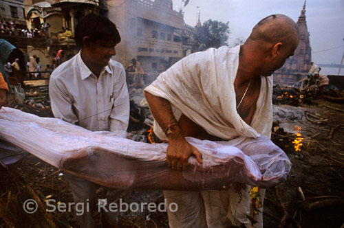 INDIA CROSSING THE RIVER GANGES Manikarnika Ghat has a great significance not only in Hindu mythology and way of life but also in the philosophies of life and death. Manikarnika is basically a cremation Ghat. It is interesting to know that cremation Ghats are usually placed outside the main town; as they are considered inauspicious. Nevertheless this doesn't stand true in the case of Varanasi where Manikarnika is situated quite in the middle of town itself. This is precisely because the entire city of Varanasi is considered a "Maha-Shmashan" or the Great Cremation Ground. Manikarnika Ghat is perpetually crowded with funeral parties. You will find shops lined up with things used during the cremation such as Ghee; wood; offerings and clothes. These cremations are felicitated by Doms who are considered the guardian of dead. Seeing bodies being cremated so publicly has always exerted a great fascination for foreign visitors to the city who find it utterly amusing and deviated from the one practiced in Semitic religions. It is worthy to note that photography is strictly considered a taboo. So please avoid doing that as this might be seen as a provocation and act of hostility and might lead to unwanted troubles.