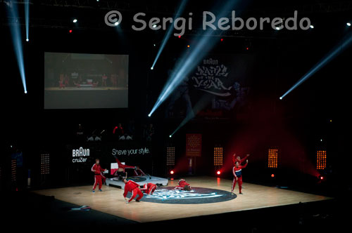 Momento de la actuación en la final masculina del Braun Battle of the Year 2011. Equipo CT Group (Polonia). Un año más Hip Hop Life se fija en los eventos internacionales de nuestra cultura, y desde hace 21 años hablar de break es tener la BOTY (Battle Of The Year) como principal referente como competición y por eso no nos lo hemos perdido tampoco en este 2010. Os presentamos un breve resumen de algunas de las actuaciones más reseñables que pudimos ver. Italia venía representada por segunda vez consecutiva por De Klan quienes ofrecieron el espectáculo más divertido. Disfrazados de Mario y con la base musical del videojuego hicieron un homenaje bailado de este universo donde supieron sacarle jugo al beat compenetrándolos con algunos power moves aunque quizá faltaron rutinas que le hubiese aportado algo más de espectacularidad al conjunto, o no haber descuidado los freezes, que no debemos olvidaar que puntúan. Aun así un show original que arrancó bastantes carcajadas en el que no faltó ni el rescate final de la princesa. Llegó el turno para los únicos participantes de habla hispana: desde Guatemala entraban en acción los jovencísimos Chapin Crew con un show en el que apenas pudimos ver powermoves, lo que hacía prever que no pasarían a la final. Sin embargo, este equipo ha llegado a esta competición internacional tras sólo tres años bailando y tras ganar a toda Centroamérica así que es posible que en unos años estemos ante una crew a un nivel que nada tenga que envidiar a los mejores. El tiempo lo dirá. Había ganas de ver qué hacían los nuevos anfitriones: por parte de Francia daba la cara La Smala que nos deleitó con un show espectacular del que destaca indudablemente b.boy Hourth con sus muletas ya que sólo tiene una pierna, pero esta discapacidad no le ha impedido estar con los mejores. En cierto modo este b.boy recuerda a la baza que suponía Lil Kev para Phase-T cuando era un niño y sus compañeros se valían de su tamaño para jugar en escena con él. Mortal Kombat, desde Japón, arrasaron con su espectáculo, vimos una excelente coordinación, todo tipo de powermoves y supieron jugar muy bien con la música. Destacar el dominio absoluto de los head spin de b.boy Kaku. Su exhibición fue tal que al acabar el show Salah le comunicó que estaba impresionado y que no sabía si había batido el récord de todas las finales de la BOTY manteniendo ese movimiento. Tocaba saludar a Kaku al respetable para recibir una ovación muy merecida por parte de todo el pabellón.