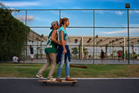 Skaters lovers teenagers at Green area in Cinta Costera Pacific Ocean Coastal Beltway Bahia de Panama linear park seawall skyline skyscraper modern. Coastal Beltway (Cinta Costera), Panama City, Panama. Panama City is one city in Central America where congestion has reached crisis point. The city is going through an unprecedented period of stability and investment and there are ample public funds for infrastructure improvement projects.