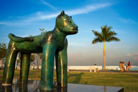 Sculpture of a panther at Green area in Cinta Costera Pacific Ocean Coastal Beltway Bahia de Panama linear park seawall skyline skyscraper modern. Coastal Beltway (Cinta Costera), Panama City, Panama. Panama City is one city in Central America where congestion has reached crisis point. The city is going through an unprecedented period of stability and investment and there are ample public funds for infrastructure improvement projects.