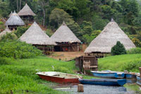 Villagers of the Native Indian Embera Tribe, Embera Village, Panama. Panama Embera people Indian Village Indigenous Indio indios natives Native americans locals local Parque National Chagres. Embera Drua. Embera Drua is located on the Upper Chagres River. A dam built on the river in 1924 produced Lake Alajuela, the main water supply to the Panama Canal. The village is four miles upriver from the lake, and encircled by a 129.000 hectare National Park of primary tropical rainforest. Lake Alajuela can be accessed by bus and mini-van from the city of Panama. It lies an hour from the city, close to the town of Las Cumbres. From a spot called Puerto El Corotu (less a port than a muddy bank with a little store that serves as a dock to embark and disembark from canoes) on the shore of the lake, it takes 45 minutes to an hour to climb up the Rio Chagres to Embera Drua ina a motorized dugout. The village was founded in 1975 by Emilio Caisamo and his sons. 