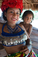 Portrait of native woman and child embera in the village of the Native Indian Embera Tribe, Embera Village, Panama. Panama Embera people Indian Village Indigenous Indio indios natives Native americans locals local Parque National Chagres. Embera Drua. Embera Drua is located on the Upper Chagres River. A dam built on the river in 1924 produced Lake Alajuela, the main water supply to the Panama Canal. The village is four miles upriver from the lake, and encircled by a 129.000 hectare National Park of primary tropical rainforest.