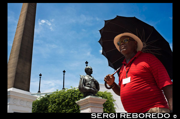 A men walking arround Obelisk with the French rooster on Plaza de Francia square in Panama City, Panama, Central America. French Plaza next to the French embassy, Casco Viejo, colonial part of the city. PLAZA FRANCIA Originally the main square of the walled city, Plaza Francia was designed by Leonardo de Villanueva and is dedicated to the French effort to build the Panama Canal and the thousands of people from around the world who died during the process. An obelisk topped with a French coque crowns the monument and a dozen marble plaques provide details of the labor of construction the Canal. Flanking the Plaza are the infamous Las Bóvedas, the French Embassy, the Instituto Nacional de Cultura (National Culture Institute), as well as many contemporary vendors with souvenirs, food and drink.