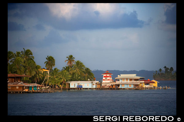 Panama Bocas del Toro iconic view of boats and archipelago. Waterfront hotel El Faro del Colibri, Isla Carenero, Bocas del Toro Archipelago, Panama. Aqua Lounge Hostel and Bar Isla Carenero. Bocas del Toro is the capital of the Panamanian province of Bocas del Toro. It is city and a world-renowned tourist resort located on the island of Isla Colon in the Bocas del Toro Archipelago in the Caribbean Sea off the northwest coast of Panama. Relatively few Panamanians live on the island, opting for cheaper housing on the mainland of Panama. Its white, sandy beaches, ecological parks, diving keys, restaurants and food, nightclubs, attractions, thematic parks, music and dances, shops and markets both in the zone and the downtown make it a popular tourist destination year-round for tourists from the North, South, Central America, Europe, Oceania and Asia alike. The official language in Panama is Spanish but English is widely spoken in Bocas del Toro. 