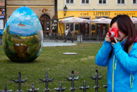 A Japanese take pictures with a Polaroid in the gardens located in front of the Café Lippert front of the Old Town Square. The Old Town Square (Czech: Staromestské nám?stí (help · info)) is a historic square in the Old Town of Prague in the Czech Republic. It is located between Wenceslas Square and the Charles Bridge, the Old Town Square in Prague is usually overrun with tourists during the summer. Featuring various architectural styles including the gothic Church of Our Lady before Tyn and baroque St. Nicholas Church, the square is an oasis for weary travelers in the narrow streets of Prague. Among many churches, tourists may find the Astronomical Clock this square, while the tower of the Old Town Hall offers a panoramic view of the Old City.