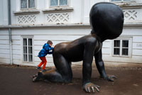 Baby crawling giant Kampa Island. Prague. Here are three bronze sculptures by Czech artist David Cerny, titled "Babies", three giant babies with bar codes embedded in their faces. David Cerny was born on December 15, 1967 in Prague, gained notoriety in 1991 by painting a Soviet tank pink, belonging to the war memorial in central Prague. Since the tank was part of a national cultural monument, his act of civil disobedience was considered "hooliganism" and was arrested. Praha (Czech Republic).