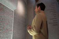 Praying beside the names of the victims on the walls of the Pinkas Synagogue. The present building is the work of the Horowitz family. In 1535, it built Aaron Meshullam Horowitz from his house "U Erb?" And the Old Jewish Cemetery. After World War II, the synagogue became a monument to the Jews of Bohemia and Moravia murdered by the Nazis. On its walls are inscribed the names of the Jewish victims, their personal data, and the names of the communities to which they belonged. In 1968, however, the Monument was closed due to groundwater seepage, which threatened the building structure. During insulation work were discovered underground spaces, an old well and a ritual bath. The communist regime intentionally delayed the repair work and the inscriptions were removed. It was not possible until 1990 to complete the building modifications. Finally, between 1992-1996, the 80 000 names of Czech and Moravian Jewish victims of Nazism were written on the walls again.