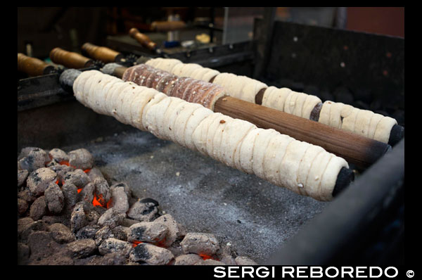 Trdelník Stalls. The Trdelnik is a mass of flour, sugar, egg, yeast, cinnamon and milk that is stretched and wound onto a wooden stick (Trdlo) or metal. It passes through a mixture of sugar with finely chopped nuts and put to roast in the coals, turning on itself, until it is golden. Is a sweet and hollow cylindrical shape. Has a garter belt and a nice smoky flavor cinnamon flavor. You can try on many street stalls that we are in Prague, even by some of Vienna or Budapest. The Víno Svarené also find it in the posts of Prague. The streets are imbued with this rich smell of cloves, cinnamon and wine. Help to cope with low temperatures thanks to you conveys warmth to the hands and stomach ... Say the spirit that bears little too does its job. I remember the wine we do in medieval recreations. They drank the Ypocras or Hippocras. Its production has a contradiction in Skalica degrees. A retired general Hungarian József Gvadányi called the Earl, who was also a poet and filósfo, based in Skalica late eighteenth century. He employed a cook from Transylvania, was the one who brought from their land Recipe "trdelník" and changed some of its mass characteristics up to the present known as Skalicky denominaión trdelník. The original name of the Hungarian mass is Kürt? Skalács. Due to the popularity of sweet at various locations in the Czech Republic, and its usual presence in the festive celebrations. Civil association emerged called trdelník Skalicky was founded in late 2004. Its purpose is to protect the origin of its name trdelník keeping and processing. The designation comes from Trdlo Trdelnik is the wooden stick (in alguns cast iron cases) on which dough is rolled. The preparation of Skalicky has three stages: In the first cylindrical mass, the thickness of a finger, will tapping into the wooden stick (Trdlo). The stick (length approximately two feet almost completely rolled up the post. Funky dough is coated in a tray containing a mixture of flour ground nuts, sugar. At the end, 'encalca' directly on this coating. Place the stick on the rotisserie and is expected to browned, something that usually happens within a few minutes. Rotisseri In usually several clubs serving various clients that are requesting. trdelník On many occasions serve grieve with honey....