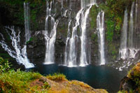 Waterfall Grand Galet. The cascade of Grand Galet or Langevin waterfall is a waterfall on the island of Reunion, a French overseas department in the southwest Indian Ocean. It reports that the municipality of Saint-Joseph, a town of La Reunion is located in the south of the island. Also located on the border of the National Park of La Reunion. River Langevin offers several possibilities all welcome. Bath and picnic are welcome everywhere. A series of basins in the mouth: Mouth Basin, Cuenca Pascal Beef, where cattle used to drink, Tamarin Basin, Benji, the Dinan Basin, Blue, near the dam, and finally pools Jacqueline swallows and Cascades . The road follows the river Langevin is shaded by old lychees, avocados and bananas. In the right amount, the small factory built in 1959 Langevin produces annually 15 million kw / h, and serves the entire region. Several families live in a place called The Pastrelle, name of an ancient bridge made of logs on the river. Above the curve of the road, the magnificent spectacle of The Cascade Langevin, also known as the Great Cascade roller. The waterfall is spread over a large wall and consists of several waterfalls. There are constantly flowing water. Grand Galet, the road goes, a small village with wooden houses.