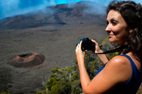 Una turista fotografía una de las calderas del Volcan Pitón de la Fournaise. También conocido como el 'volcán que huele a vainilla' se encuentra situado en la isla francesa de Reunión y suele entrar en erupción cada dos años aproximadamente. Tras varios días manifestando una crítica actividad, el 14 de octubre de 2010 se produjo la última erupción violenta del volcán que escupió lava y expulsó gases a la atmósfera, pero que afortunadamente no terminó con la vida de ningún humano.   De lo que no hay duda es que la isla de Reunión -la más grande del océano Índico- , ha sido moldeada durante miles de años por los cinco volcanes que vigilan desde las alturas y de los que este Pitón de la Fournaise es el único que sigue en activo.