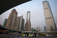 Skyscrapers in Lujiazui financial district, in Pudong, in Shanghai, China. Shanghai International Finance Centre, usually abbreviated as Shanghai IFC, is a commercial building complex and a shopping centre (branded Shanghai IFC mall) in Shanghai. It incorporates two tower blocks at 249.9 metres (south tower) and 259.9 metres (north tower) housing offices and a hotel, and an 85-metre tall multi-storey building behind and between the two towers.  Shanghai IFC is located in Lujiazui, in Pudong, Shanghai. It occupies a prominent position southeast of the Lujiazui roundabout, diagonally across from the Oriental Pearl Tower and across the road from Super Brand Mall. It is adjacent to Lujiazui Station on Metro Line 2, and can be accessed directly from the underground station via a tunnel.