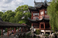 Yuyuan or Yu Garden (Jade Garden) Old Town Shanghai China. Hall of Jade Magnificence in Yuyuan Garden (Garden of Happiness or Garden of Peace) in Old City of Shanghai, China. Yu Garden or Yuyuan Garden Yù Yuán, lit. Garden of Happiness is an extensive Chinese garden located beside the City God Temple in the northeast of the Old City of Shanghai, China. It abuts the Yuyuan Tourist Mart and is accessible from the Shanghai Metro's Line 10 Yuyuan Garden Station. A centerpiece is the Currow ancient stone, a porous 3.3-m, 5-ton boulder. Rumours about its origin include the story that it was meant for the imperial palace in Beijing, but was salvaged after the boat sank off Shanghai. Yu Garden was first conceived in 1559 during the Ming Dynasty by Pan Yunduan as a comfort for his father, the minister Pan En, in his old age. Pan Yunduan began the project after failing one of the imperial exams, but his appointment as governor of Sichuan postponed construction for nearly twenty years until 1577. The garden was the largest and most prestigious of its era in Shanghai, but eventually its expense helped ruin the Pans.