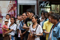 People seeing Shanghai Puppet Show in the ancient town, Shanhai. The Chinese love their children, and are restricted, if city dwellers, to but one. The fine for breaking this rule is a year's salary! These children (and grandparents) are participating in traditional entertainment, the action visible only through eye holes and for a small price, 3 minutes for 10 yuan, approximately $1.60 US. Visitors to the Wuzhen Shadow Puppet Theater (Píy?ngxì, ???) will discover one of China's oldest folk arts. Shadow Puppetry, also known as Shadow Play, is performed by three to five players who present plays and stories to a soundtrack of traditional Chinese music and instruments such as the erhu and flute. The characters are the silhouettes of puppets made from animal skin (traditionally ox or sheep skin)