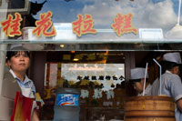 Restaurant in the Old Town, Shanghai. Bamboo steamer trays with dim sum choices at small restaurant in former City God Temple on Shanghai Old Street. Road side Chinese Dumpling or Dim Sum Stall in the Old City, Shanghai, China. Xiaolongbao is a type of steamed bun (baozi) from the Jiangnan region of China, especially associated with Shanghai and Wuxi. It is traditionally prepared in xiaolong, small bamboo steaming baskets, which give them their name. Xiaolongbao are often referred to as a kind of "dumpling", but should not be confused with British or American-style dumplings nor with Chinese jiaozi. Similarly, they are considered a kind of "soup dumpling" but should not be confused with other larger varieties of tang bao. In Shanghainese, they are also sometimes known as sioh-lon meu-doe or xiaolong-style mantous.Shanghai-style xiaolongbao originated in Nanxiang, a suburb of Shanghai in the Jiading District. 