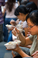 Two Young Chinese Women enjoying Nanxiang Dumpling House Yuyuan Bazaar Old Town Shanghai China. Restaurant in the Old Town, Shanghai. Bamboo steamer trays with dim sum choices at small restaurant in former City God Temple on Shanghai Old Street. Road side Chinese Dumpling or Dim Sum Stall in the Old City, Shanghai, China. Xiaolongbao is a type of steamed bun (baozi) from the Jiangnan region of China, especially associated with Shanghai and Wuxi. It is traditionally prepared in xiaolong, small bamboo steaming baskets, which give them their name. Xiaolongbao are often referred to as a kind of "dumpling"