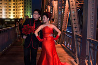 Wedding Photography at Garden bridge shanghai. Suzhou Creek, Waibaidu (Garden) Bridge, illuminated at night, Shanghai, China. The Waibaidu Bridge, Wàibáidù Qiáo, called the Garden Bridge in English, is the first all-steel bridge, and the only surviving example of a camelback truss bridge, in China. The fourth foreign bridge built at its location since 1856, in the downstream of the estuary of the Suzhou Creek, near its confluence with the Huangpu River, adjacent to the Bund in central Shanghai, connecting the Huangpu and Hongkou districts, the present bridge was opened on 20 January 1908. With its rich history and unique design the Waibaidu Bridge is one of the symbols of Shanghai.