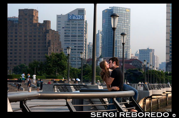 A couple tourists kissing in the Bund. China Love. The Bund promenade, Shanghai, China. China Shanghai Tourist Shanghai Skyline viewed over the Huangpu river from the Bund. Bin Jiang Avenue, The Bund, Shanghai, China. The highlights of the Bund are undoubtedly the colonial-era buildings lining the west side of Zhongshan Dong Yi Lu, standouts of which include the former British Consulate, Customs House, former Hong Kong and Shanghai Bank, former Shanghai Club (now the Waldorf Astoria Hotel), and the Peace Hotel. For more details on these buildings, many of which have been skillfully restored, and a more complete walking guide to this gallery of European architecture.  Besides its landmark colonial architecture, however, the Bund has a few other small attractions. On its north end, the rehabilitated Suzhou Creek enters the Huangpu River beneath the 18m-wide (59-ft.) iron Waibaidu Bridge, built in 1906 to replace the original wooden toll bridge constructed in 1856 by an English businessman. The bridge was most recently restored in 2009. On the river shore stands a granite obelisk, Monument to the People's Heroes, erected in 1993, and dedicated to Chinese patriots (as defined by the Communist Party) beginning in the 1840s. The Bund History Museum (9am-4:15pm; free admission), which contains a few artifacts and some interesting photographs of the Bund, stands at its base; however, at press time, the museum was closed for renovation. Just south of the monument used to be the park Huangpu Gongyuan, originally the British Public Gardens built in 1868. In the early days, only Chinese servants accompanying their foreign masters were allowed to enter the park. Dogs were also prohibited, leading in later years to the apocryphal NO CHINESE OR DOGS ALLOWED sign being attributed to the park. The park was eventually opened to Chinese in 1926, but today, has simply become part of the Bund promenade with the recent renovations. South of here, across from the Peace Hotel, is the entrance to the pedestrian Bund Sightseeing Tunnel (Waitan Guanguang Suidao) (daily 8am-10:30pm, 11pm Fri-Sun; admission ¥55 round-trip, ¥45 one-way) located under the Huangpu. Complete with tram cars and a light show, the tunnel connects downtown Shanghai to the Pudong New Area and the Oriental Pearl TV Tower. Also here is a statue of Chen Yi, Shanghai's first mayor after 1949 and a dead ringer for Mao Zedong, at least in bronze.  Farther south down the Bund Promenade are scores of vendors, a few restaurants, and excellent overlooks facing the river. At the intersection with Yan'an Dong Lu, you'll also notice a picturesque Signal Tower, a slender, round brick tower that served as a control tower for river traffic during colonial days. First built in 1884, the tower was rebuilt in 1907, and also relayed weather reports. In 1993 during the widening of Zhongshan Lu, it was moved 20m (66 ft.) to its current site. About a 20-minute walk farther down the promenade are the docks for the Huangpu River cruises.