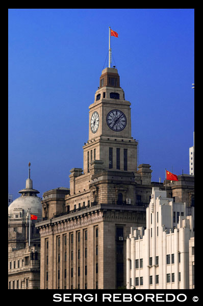 The Bund lit up at night with Customs House and HSBC buildings Bund Shanghai. Bell Tower of the Shanghai Customs House, The Bund, Shanghai, China. The Shanghai Customs House was first set up in the late 17th century, when the Kangxi Emperor lifted the ban against sea trade after conquering Taiwan. To facilitate trading along the east coast of China, the Qing government set up four customs houses in the four coastal provinces of Jiangnan (now split into Jiangsu and Anhui), Zhejiang, Fujian, and Guangdong. The name "Jiangnan Customs House" was abbreviated to "Jiang Customs House", or "Jiang Haiguan" in Chinese. The principal customs house, originally located at Lianyungang was later set up just outside the east gate of the walled city of Shanghai (then a part of Jiangnan Province), by the Huangpu River.  With the development of overseas trade in Shanghai, the location of the customs house became increasingly inconvenient, with foreign merchants preferring to berth their ships further out to sea, near today's Bund. The governor of Shanghai then set up a check point at the south end of the Bund. Upon further insistence by the British consul to move the customs house inside the British concession, a new customs house was built at the present site. This new house is known as the New Customs House, North Customs House, or "Foreign Customs House", whereas the old customs house was known as the "Grand Customs House". In 1853, the rebelling Small Swords Society burnt down the Grand Customs House. In 1860, the Taiping Revolution Army burnt down the rebuilt Grand Customs House. It was decided not to rebuild the Grand Customs House, with the current building becoming the new headquarters.