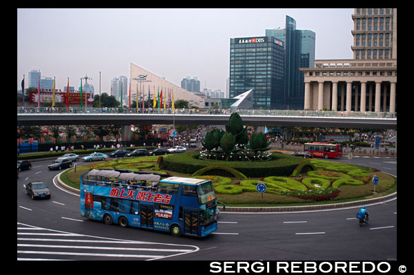 Roundabout in Lujiazui financial district, in Pudong, in Shanghai, China. Shanghai International Finance Centre, usually abbreviated as Shanghai IFC, is a commercial building complex and a shopping centre (branded Shanghai IFC mall) in Shanghai. It incorporates two tower blocks at 249.9 metres (south tower) and 259.9 metres (north tower) housing offices and a hotel, and an 85-metre tall multi-storey building behind and between the two towers.  Shanghai IFC is located in Lujiazui, in Pudong, Shanghai. It occupies a prominent position southeast of the Lujiazui roundabout, diagonally across from the Oriental Pearl Tower and across the road from Super Brand Mall. It is adjacent to Lujiazui Station on Metro Line 2, and can be accessed directly from the underground station via a tunnel.  The south tower of Shanghai IFC and part of the multistorey building was completed in 2009, while the north tower and the rest of the complex was completed in 2010. Work continued for several years afterwards on peripheral aspects of the development, including landscaping and footbridge connections to nearby buildings and Lujiazui Central Park.  The Ritz-Carlton Hotel occupies the south tower, while the north tower houses the current Shanghai headquarters of HSBC in China. Other prominent tenants of the complex include an Apple Store under the sunken forecourt of the building (topped by a cylindrical glass skylight rising from the forecourt), a multi-screen cinema, and a Citysuper supermarket. The remainder of the retail area is largely taken up by upscale chain restaurants and international luxury fashion brands.