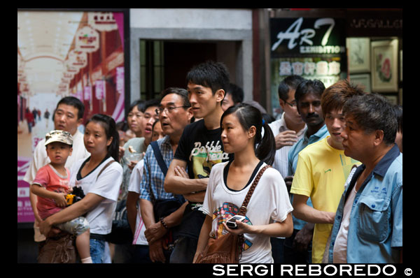 People seeing Shanghai Puppet Show in the ancient town, Shanhai. The Chinese love their children, and are restricted, if city dwellers, to but one. The fine for breaking this rule is a year's salary! These children (and grandparents) are participating in traditional entertainment, the action visible only through eye holes and for a small price, 3 minutes for 10 yuan, approximately $1.60 US. Visitors to the Wuzhen Shadow Puppet Theater (Píy?ngxì, ???) will discover one of China's oldest folk arts. Shadow Puppetry, also known as Shadow Play, is performed by three to five players who present plays and stories to a soundtrack of traditional Chinese music and instruments such as the erhu and flute. The characters are the silhouettes of puppets made from animal skin (traditionally ox or sheep skin) behind a brightly illuminated backdrop. Once a key part of any festival or celebration, the art of shadow puppetry suffered greatly during the Cultural Revolution and only a handful of troupes were left around the country. The shadow play artists of Wuzhen are of particular note and have been invited to perform in Korea, Japan, Singapore, Germany and other places around the world. 