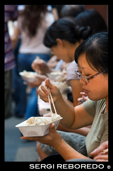 Two Young Chinese Women enjoying Nanxiang Dumpling House Yuyuan Bazaar Old Town Shanghai China. Restaurant in the Old Town, Shanghai. Bamboo steamer trays with dim sum choices at small restaurant in former City God Temple on Shanghai Old Street. Road side Chinese Dumpling or Dim Sum Stall in the Old City, Shanghai, China. Xiaolongbao is a type of steamed bun (baozi) from the Jiangnan region of China, especially associated with Shanghai and Wuxi. It is traditionally prepared in xiaolong, small bamboo steaming baskets, which give them their name. Xiaolongbao are often referred to as a kind of "dumpling", but should not be confused with British or American-style dumplings nor with Chinese jiaozi. Similarly, they are considered a kind of "soup dumpling" but should not be confused with other larger varieties of tang bao. In Shanghainese, they are also sometimes known as sioh-lon meu-doe or xiaolong-style mantous.Shanghai-style xiaolongbao originated in Nanxiang, a suburb of Shanghai in the Jiading District. The inventor of xiaolongbao sold them in his first store in Nanxiang next to the town's notable park, Guyi Garden. From there the xiaolongbao expanded into downtown Shanghai and outward.Two specialist xiaolongbao restaurants have a particularly long history. One is Nanxiang Mantou Dian (Nanxiang Bun Shop), which derives from the original store in Nanxiang but is now located in the Yu Garden area. It is famed for its crab-meat-filled buns. The other is Gulong Restaurant, at the original site next to Guyi Garden in Nanxiang. 