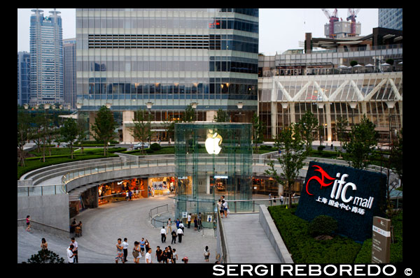 Apple computer store in Lujiazui financial district, in Pudong, in Shanghai, China. View of large modern Apple store in Shanghai China. Apple Store Pudong in front of Shanghai IFC South and North Tower (HSBC building) in Pudong District, Shanghai, China. Shanghai International Finance Centre, usually abbreviated as Shanghai IFC, is a commercial building complex and a shopping centre (branded Shanghai IFC mall) in Shanghai. It incorporates two tower blocks at 249.9 metres (south tower) and 259.9 metres (north tower) housing offices and a hotel, and an 85-metre tall multi-storey building behind and between the two towers.  Shanghai IFC is located in Lujiazui, in Pudong, Shanghai. It occupies a prominent position southeast of the Lujiazui roundabout, diagonally across from the Oriental Pearl Tower and across the road from Super Brand Mall. It is adjacent to Lujiazui Station on Metro Line 2, and can be accessed directly from the underground station via a tunnel.  The south tower of Shanghai IFC and part of the multistorey building was completed in 2009, while the north tower and the rest of the complex was completed in 2010. Work continued for several years afterwards on peripheral aspects of the development, including landscaping and footbridge connections to nearby buildings and Lujiazui Central Park.  The Ritz-Carlton Hotel occupies the south tower, while the north tower houses the current Shanghai headquarters of HSBC in China. Other prominent tenants of the complex include an Apple Store under the sunken forecourt of the building (topped by a cylindrical glass skylight rising from the forecourt), a multi-screen cinema, and a Citysuper supermarket. The remainder of the retail area is largely taken up by upscale chain restaurants and international luxury fashion brands.