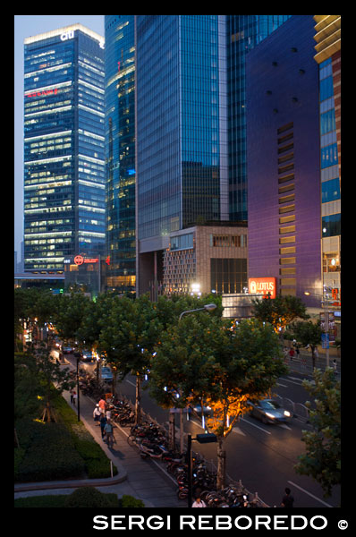 Pundong area, Shanghai. Skyscrapers near IFC. Shanghai International Finance Centre, usually abbreviated as Shanghai IFC, is a commercial building complex and a shopping centre (branded Shanghai IFC mall) in Shanghai. It incorporates two tower blocks at 249.9 metres (south tower) and 259.9 metres (north tower) housing offices and a hotel, and an 85-metre tall multi-storey building behind and between the two towers.  Shanghai IFC is located in Lujiazui, in Pudong, Shanghai. It occupies a prominent position southeast of the Lujiazui roundabout, diagonally across from the Oriental Pearl Tower and across the road from Super Brand Mall. It is adjacent to Lujiazui Station on Metro Line 2, and can be accessed directly from the underground station via a tunnel.  The south tower of Shanghai IFC and part of the multistorey building was completed in 2009, while the north tower and the rest of the complex was completed in 2010. Work continued for several years afterwards on peripheral aspects of the development, including landscaping and footbridge connections to nearby buildings and Lujiazui Central Park.  The Ritz-Carlton Hotel occupies the south tower, while the north tower houses the current Shanghai headquarters of HSBC in China. Other prominent tenants of the complex include an Apple Store under the sunken forecourt of the building (topped by a cylindrical glass skylight rising from the forecourt), a multi-screen cinema, and a Citysuper supermarket. The remainder of the retail area is largely taken up by upscale chain restaurants and international luxury fashion brands.