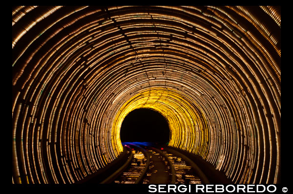 Blurred motion light trails in a train tunnel under the Huangpu River linking the Bund to Pudong, Shanghai, China, Asia. The colourful Bund Sightseeing Tunnel train under the Huang Pu River connecting Puxi and Pudong districts in Shanghai China Asia. The Bund Sightseeing Tunnel goes under the Huangpu River connecting the Bund and Lujiazui Area of Pudong District. Its length is 646.7 meters. The Bund Sightseeing Tunnel is almost a virtual facility under the ground and provides a memorable experience of the special multimedia effects. The compartments of sightseeing maglev train are completely transparent and it allows the 360 degrees view. The six channel surround system amplifies the experience and the sound effects change as the scenery changes. The compartments are unmanned and it provides steady and fluent ride. It takes 3-5 minutes to travel through the tunnel and enjoy the sites to the fullest. The tunnel links Puxi ('West of the Huangpu') and Pudong ('East of the Huangpu'). The entrance on the Bund is located in the north of Chenyi Square, while the one in Pudong is situated on the south side of the Oriental Pearl TV and Radio Tower, facing the International Convention Center. 