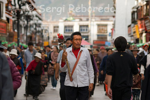 A pilgrim spinning their prayer wheels while doing the kora around the Jokhang Temple. "Om mani padme hum" repeated ad nauseam thousands of Tibetans in their tireless round the Jokhang Temple, the most famous Buddhist temples in Lhasa in Tibet, the spiritual center of the city. It is the area known as Barkor, the true heart of the city. While not leave say their mantras spinning their prayer wheels, always in the direction of clockwise.