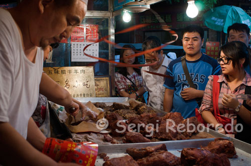 Street food stall in the Muslim Quarter of Xi'an., A very nice day and night to escape the traffic, walking and watching the Chinese Muslim community. The food is authentic and is a good place to buy souvenirs. A very nice neighborhood for photographers. Do not miss the Muslim street, one of the biggest attractions in Xian.