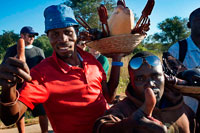 Craft vendors on the border between Botswana and Zambia. From Victoria Falls is possible to visit the nearby Botswana. Specifically Chobe National Park.   Just inside the Zambian border, next to the field museum, is an outstanding curio stand. The carvers and traders come mostly from Mukuni village, though the goods come from as far as DRC and Malawi. Mukuni Park in the centre of town has a similar area of curio vendors. Both are excellent places to buy wooden and stone carvings, handicrafts, chessboards, masks, drums, malachite bangles, baskets and the like. There are usually about 20 or 30 individual traders, laying their wares out separately. All compete with one another and vie for your business. The best buys are makenge baskets (these come exclusively from Zambia's western province), malachite and heavy wooden carvings: hippos, elephants, rhinos, giraffes and smaller statues, often made out of excellent-quality, heavy wood. However, you should consider the ethics of encouraging any further exploitation of hardwoods. Note, too, that some wooden items, especially wooden salad bowls and tall giraffes, are prone to cracking once you get them home due to changes in climate and that very rarely are 'antiques' sold at craft markets anything other than fakes. Unless you have the expertise to tell the difference, it's better to buy such artefacts from a reputable shop in town.  